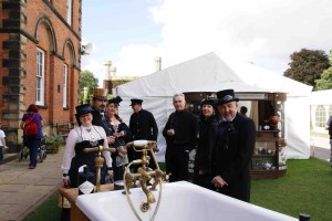 A group of steampunks at the Asylum gather around a bathtub of gin