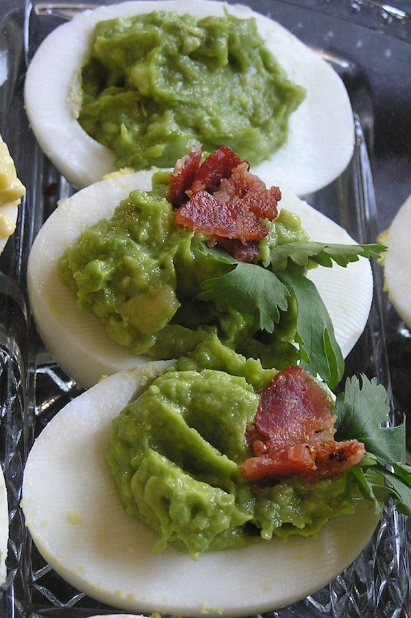 Deviled Eggs made with avocado bacon and devils cut bourbon